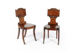 A pair of Regency mahogany hall chairs