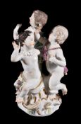 A Meissen allegorical group of three putti