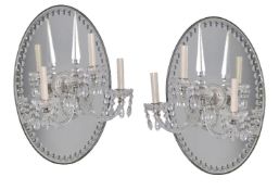 A pair of cut glass and silver plated three light girandoles in George III taste