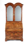 A Queen Anne walnut, burr-walnut and feather banded bureau cabinet