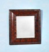 A William & Mary olivewood oyster veneered cushion framed mirror