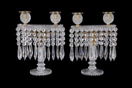 A fine pair of Regency cut glass and gilt metal mounted twin light lustre candelabra