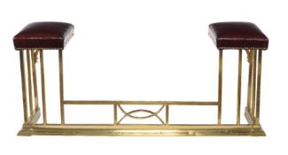 A brass and faux leather upholstered club fender