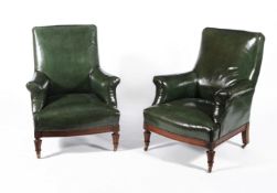 A pair of mahogany and green leather upholstered armchairs
