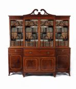 A George III 'plum pudding' mahogany and satinwood banded breakfront secretaire library bookcase