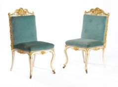 A pair of carved giltwood and cream painted side chairs