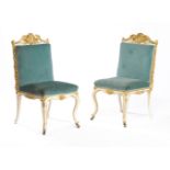 A pair of carved giltwood and cream painted side chairs