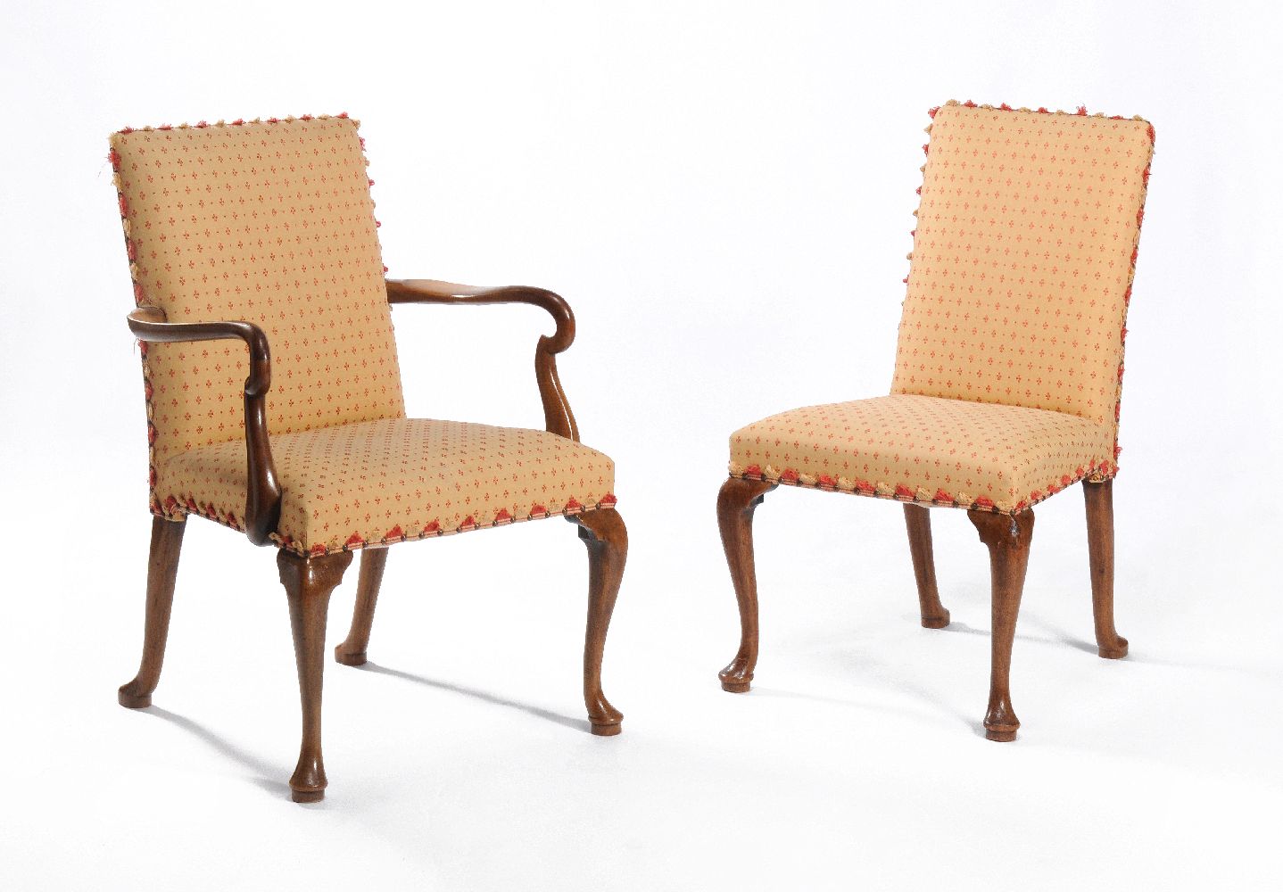 A set of sixteen walnut and upholstered dining chairs