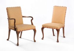 A set of sixteen walnut and upholstered dining chairs