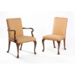 A set of sixteen walnut and upholstered dining chairs