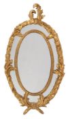 A pair of giltwood and composition oval wall mirrors