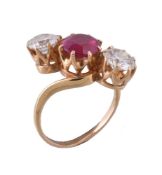 A three stone ruby and diamond crossover ring