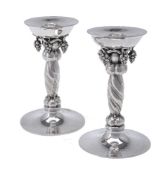 Georg Jensen, a pair of Danish silver Grape pattern candlesticks
