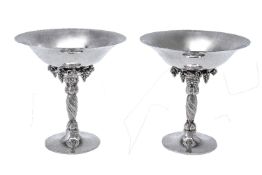 Georg Jensen, a pair of Danish silver Grape pattern pedestal bowls