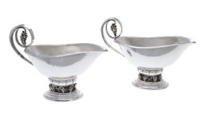 Georg Jensen, a pair of Danish silver Grape pattern sauce or gravy boats