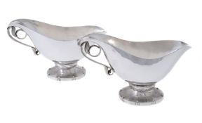 Georg Jensen, a pair of Danish silver Blossom pattern sauce or gravy boats