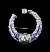 A 1930s diamond, sapphire and emerald crescent brooch