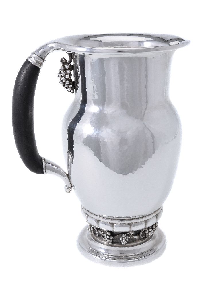 ϒ Georg Jensen, a Danish silver Grape pattern pitcher or jug