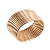 A broad gold coloured cuff bangle by Weingrill