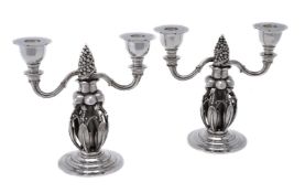 Georg Jensen, a pair of Danish silver Fir Cone twin light candelabra