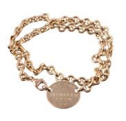 An 18 carat gold oval tag choker by Tiffany & Co.