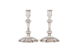 A pair of early George II cast silver candlesticks by Thomas Causton