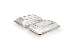 A pair of George III silver rounded rectangular entrée dishes and covers by Timothy Renou