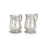 A matched pair of silver baluster mugs
