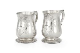 A matched pair of silver baluster mugs
