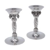 Georg Jensen, a pair of Danish silver Grape pattern candlesticks