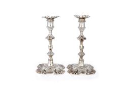 A pair of early George III cast silver candlesticks by John Hyatt & Charles Semore