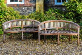 A pair of teak garden benches