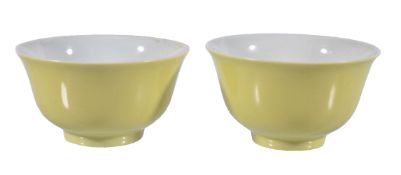 A pair of Chinese yellow-ground small bowls