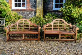 A pair of teak garden benches in the manner of designs by Lutyens