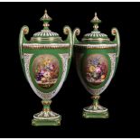 Two similar Royal Worcester green-ground and gilt urns and cover signed by W.A.Hawkins