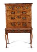 A walnut and featherbanded chest on stand