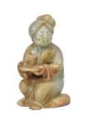 A Chinese celadon and russet jade figure of a lady