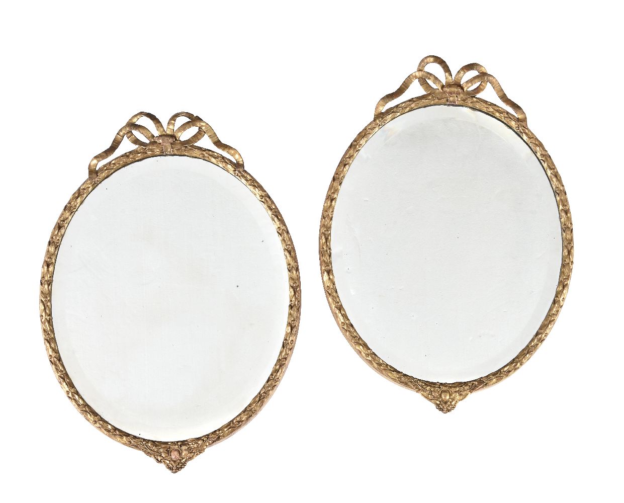 A pair of giltwood and composition oval wall mirrors