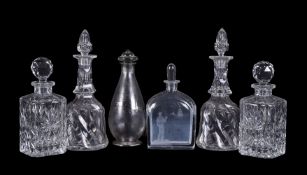 An assortment of mostly glass decanters