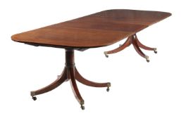 A mahogany and satinwood banded twin pillar dining table