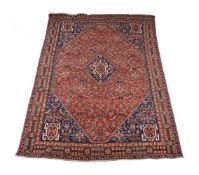 A Qashqai rug with dark red and blue ground and central lozenge