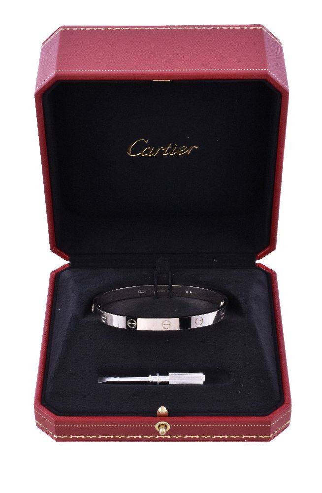 An 18 carat gold 'Love' bangle by Cartier, the polished bracelet with screw detail, ... - Image 2 of 3