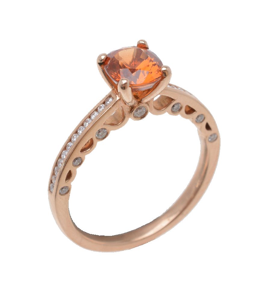 An orange sapphire and diamond ring