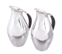 Georg Jensen, a pair of Danish silver water jugs or pitchers