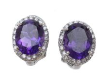 A pair of amethyst and diamond earrings