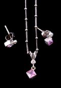 A pink sapphire and diamond pendant and earrings