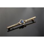 An 18ct Gold Brooch set central Sapphire and Two Diamonds
