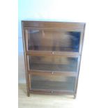 A Gunn Furniture Co Vintage oak three-stage sectional bookcase with up and over glazed panel doors