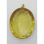 Large oval facet cut citrine Pendant in a pierced setting, the loop marked 15.