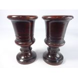 Pair of turned and stained mahogany pedestal urns,